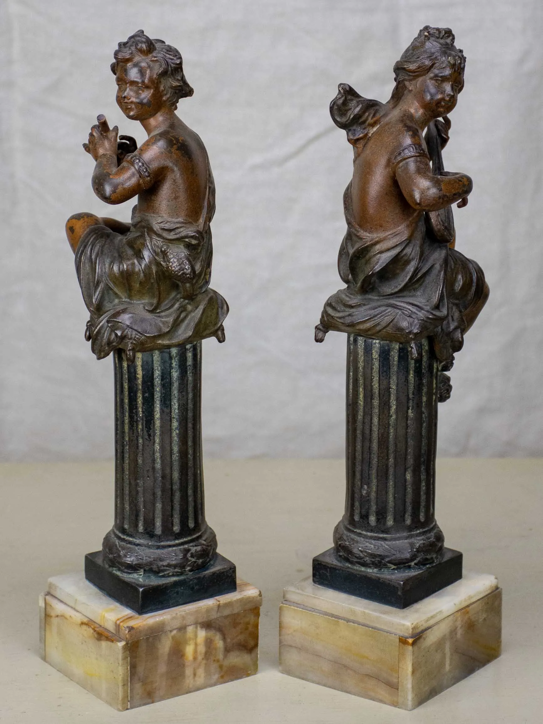Antique French statues of angels playing music