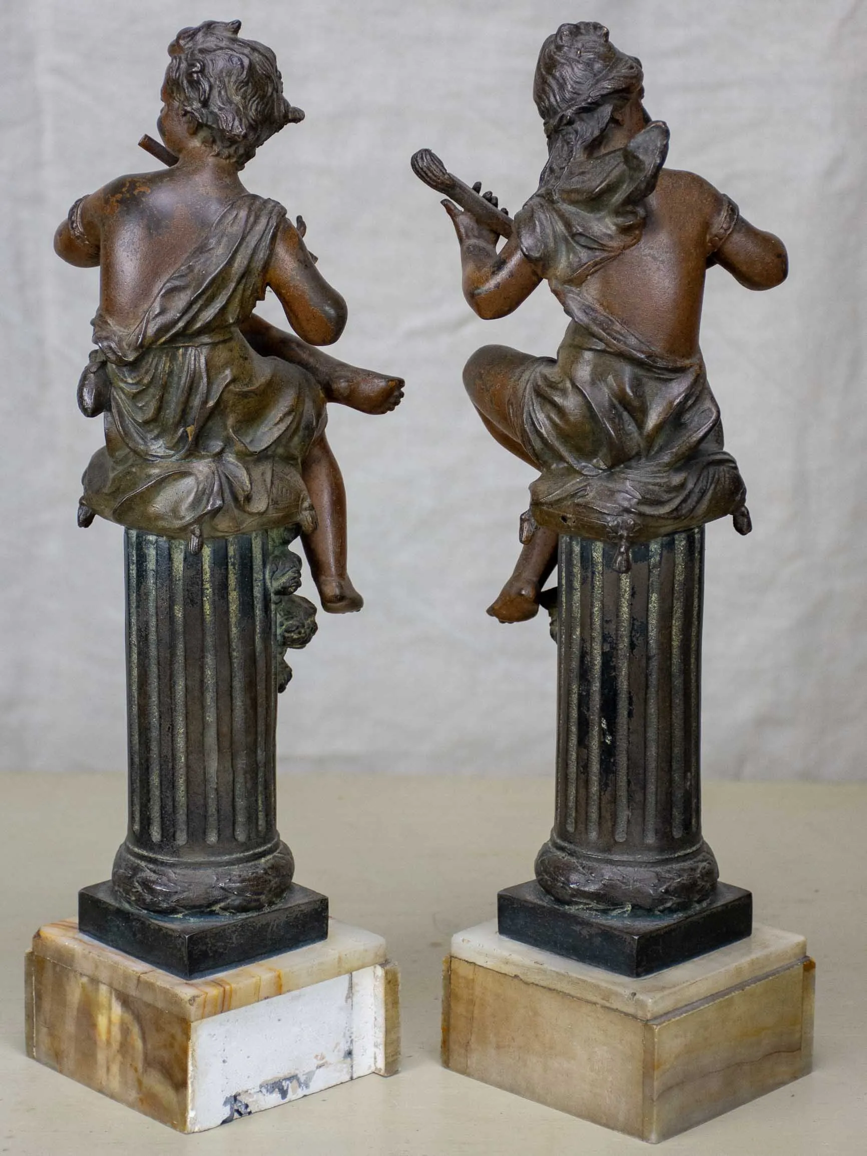 Antique French statues of angels playing music