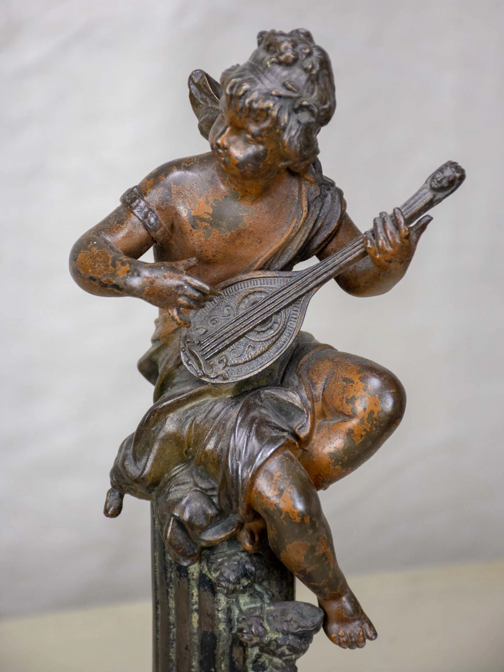 Antique French statues of angels playing music