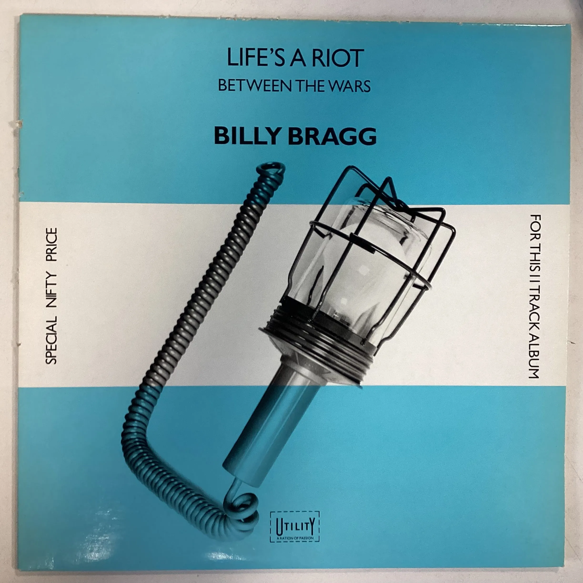 BRAGG, BILLY = LIFE’S A RIOT/BETWEEN THE WARS (CDN 1985) (USED)
